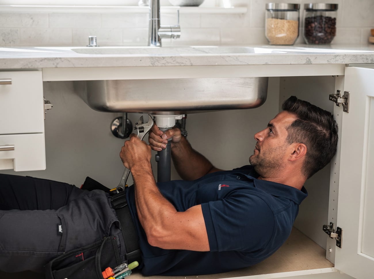 A plumber from Halloran & Sons Plumbing on the job